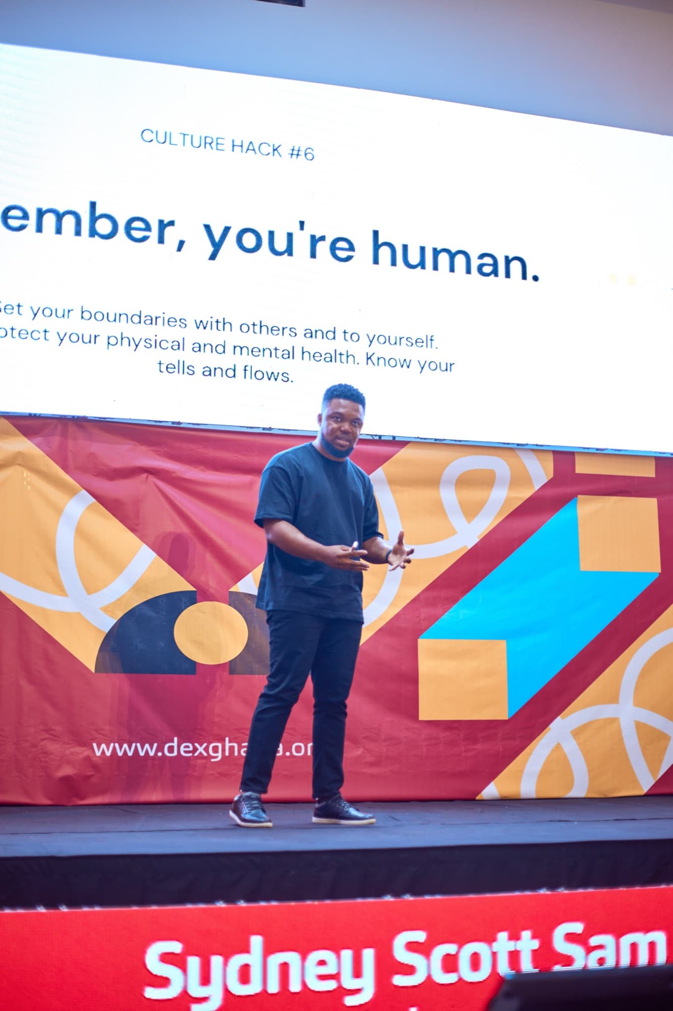 Sydney delivering a keynote on stage